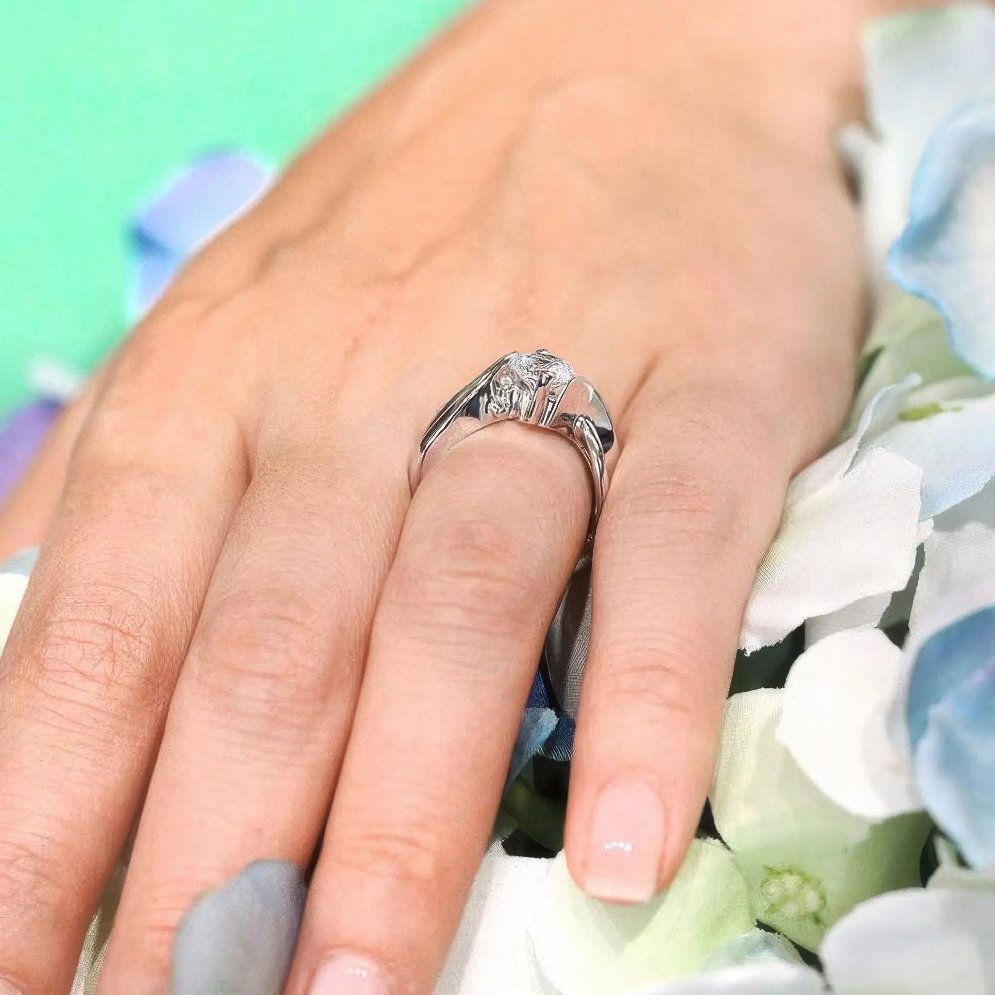 Double wire trim lab diamond solitaire ring worn on a hand, showcasing a round center stone and accenting wire trims.