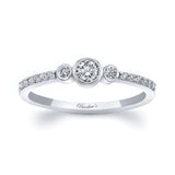 Mia three stone diamond promise ring with bezel set center and shared prong diamonds on a sleek white gold band.