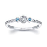 Mia Three Stone Aquamarine Accent Diamond Promise Ring featuring a center diamond and side aquamarine gemstones.