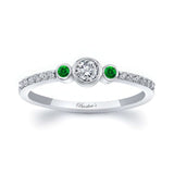 Mia Three Stone Emerald Accent Diamond Promise Ring featuring a diamond center and emerald gemstones on each side.