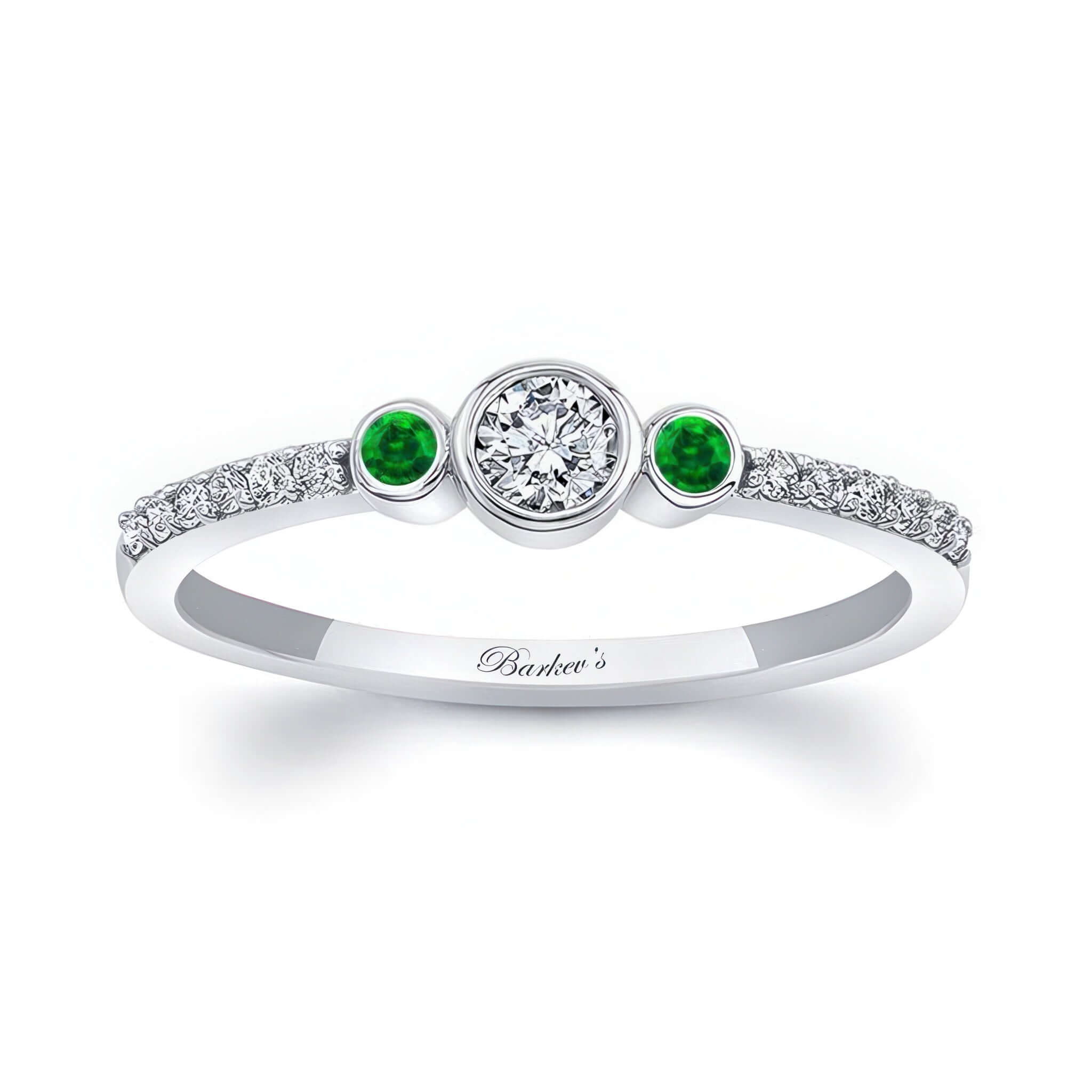 Mia Three Stone Emerald Accent Diamond Promise Ring featuring a diamond center and emerald gemstones on each side.