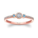 Mia Three Stone Aquamarine Accent Diamond Promise Ring with a diamond center and aquamarine side stones on rose gold band.
