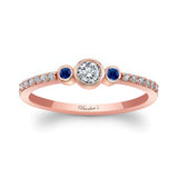 Mia three stone blue sapphire accent diamond promise ring with a brilliant center diamond and rose gold band.