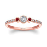 Mia Three Stone Ruby Accent Diamond Promise Ring with a central diamond and ruby accents on a rose gold band.