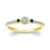 Mia three stone blue sapphire accent diamond promise ring in yellow gold with bezel set diamond and cascading diamonds.