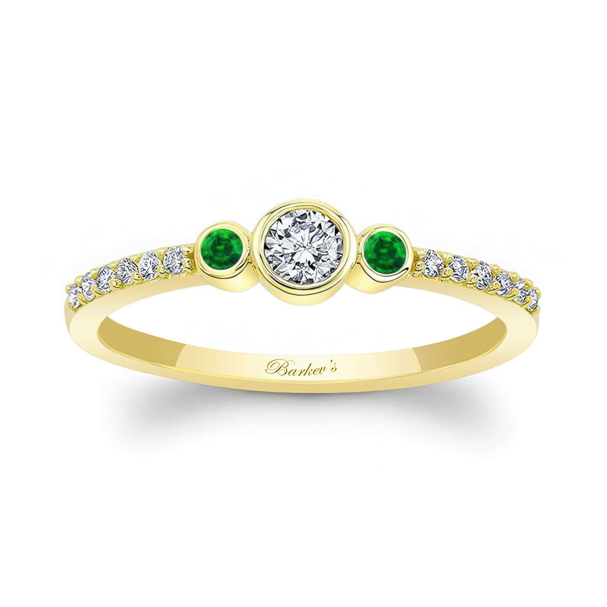 Mia Three Stone Emerald Accent Diamond Promise Ring featuring a bezel set diamond and emerald side stones in yellow gold.