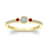 Three stone ruby accent diamond promise ring with a diamond center and radiant ruby sides, set in yellow gold.