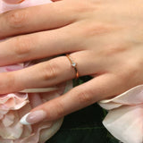 Elegant Aria Princess Cut Diamond Promise Ring showcased on hand with floral background.