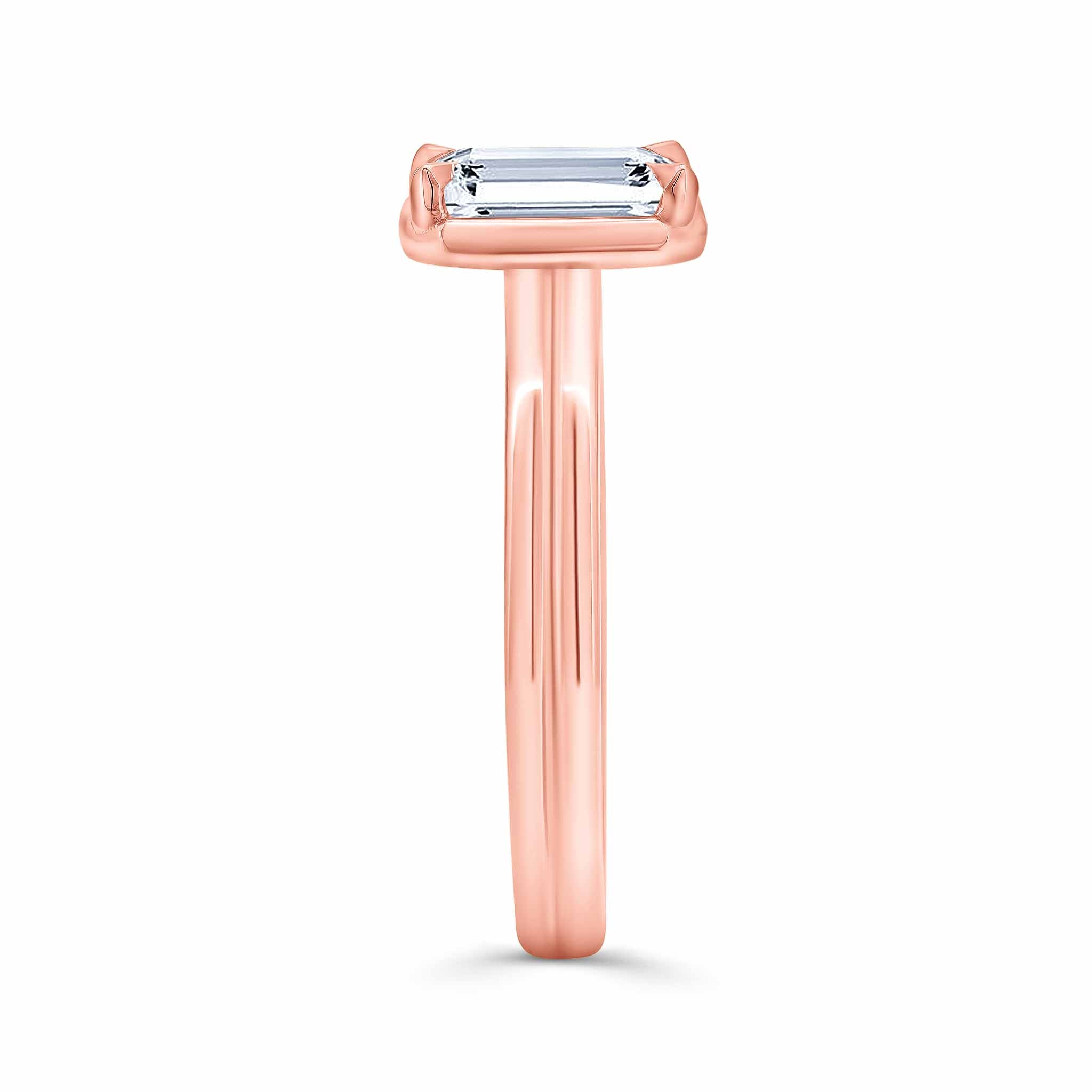 Double band 2 carat emerald cut diamond solitaire ring in rose gold, showcasing elegant design and exceptional brilliance.