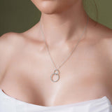 Double Beaded Circle Necklace elegantly displayed on a model, showcasing intertwined circles in 14k white gold.