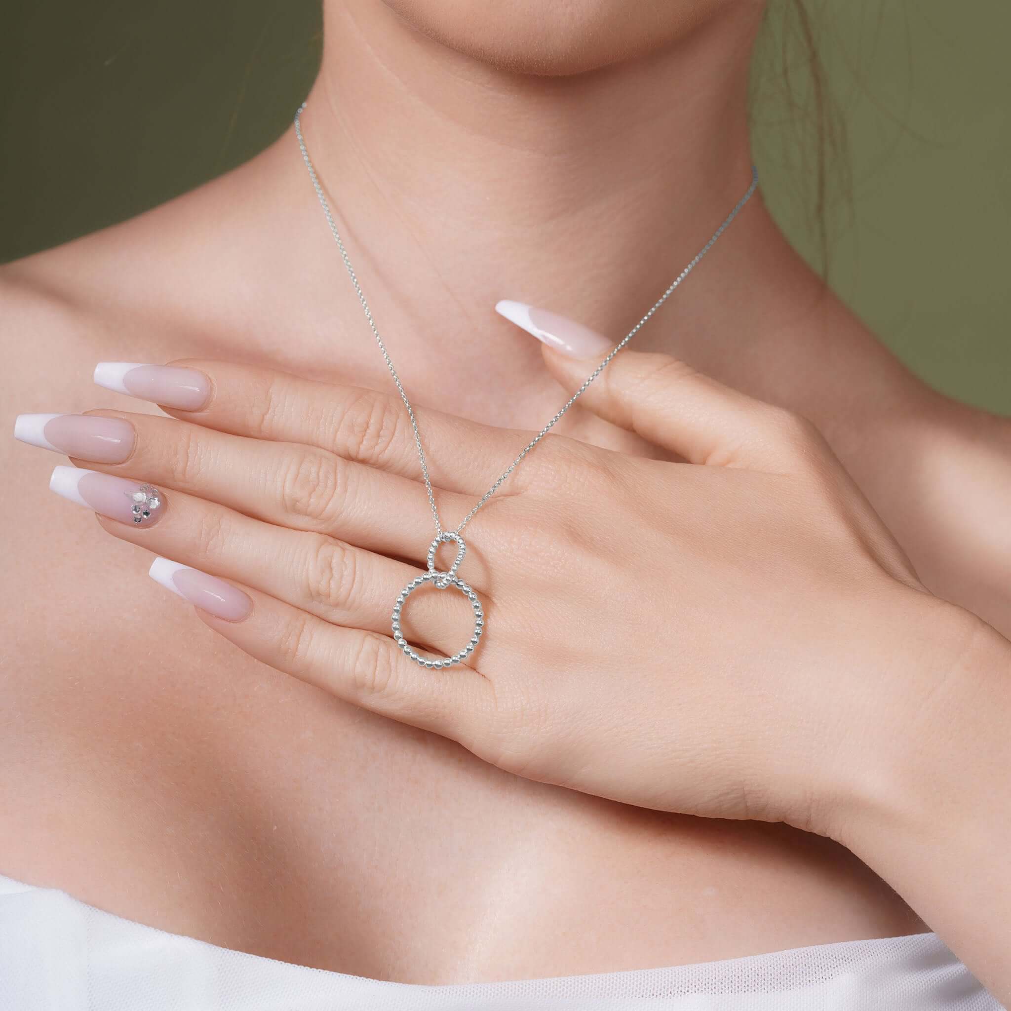Model showcasing the Double Beaded Circle Necklace in silver, with beaded circles elegantly intertwined on a delicate chain.