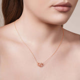 Gold Double Circle Necklace on a model, showcasing intertwined circles in polished and beaded design.