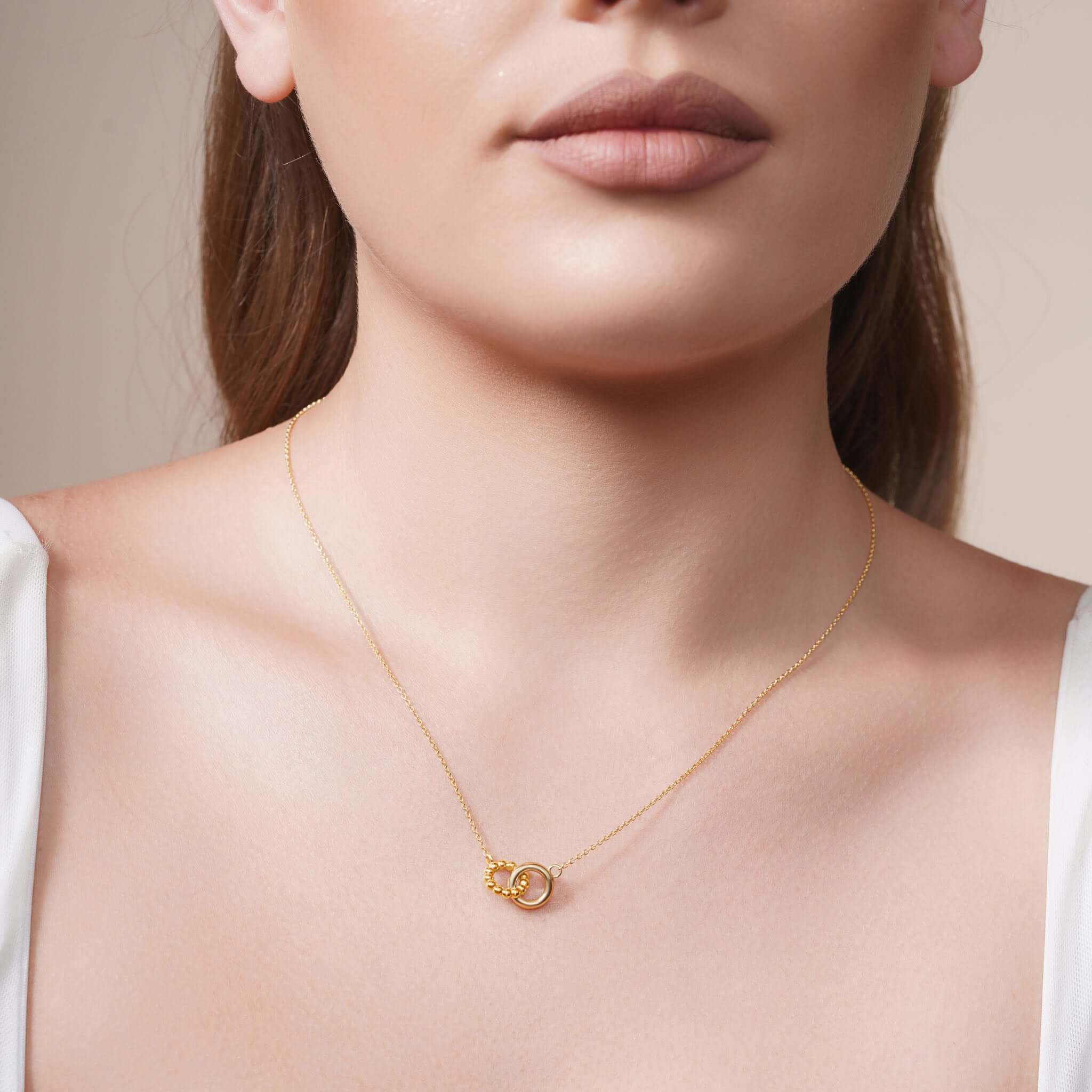 Vermeil Double Circle Necklace featuring intertwined polished and beaded circles worn on a model.