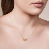 Gold Double Circle Necklace worn elegantly, featuring intertwined polished and beaded circles, showcasing refined style.
