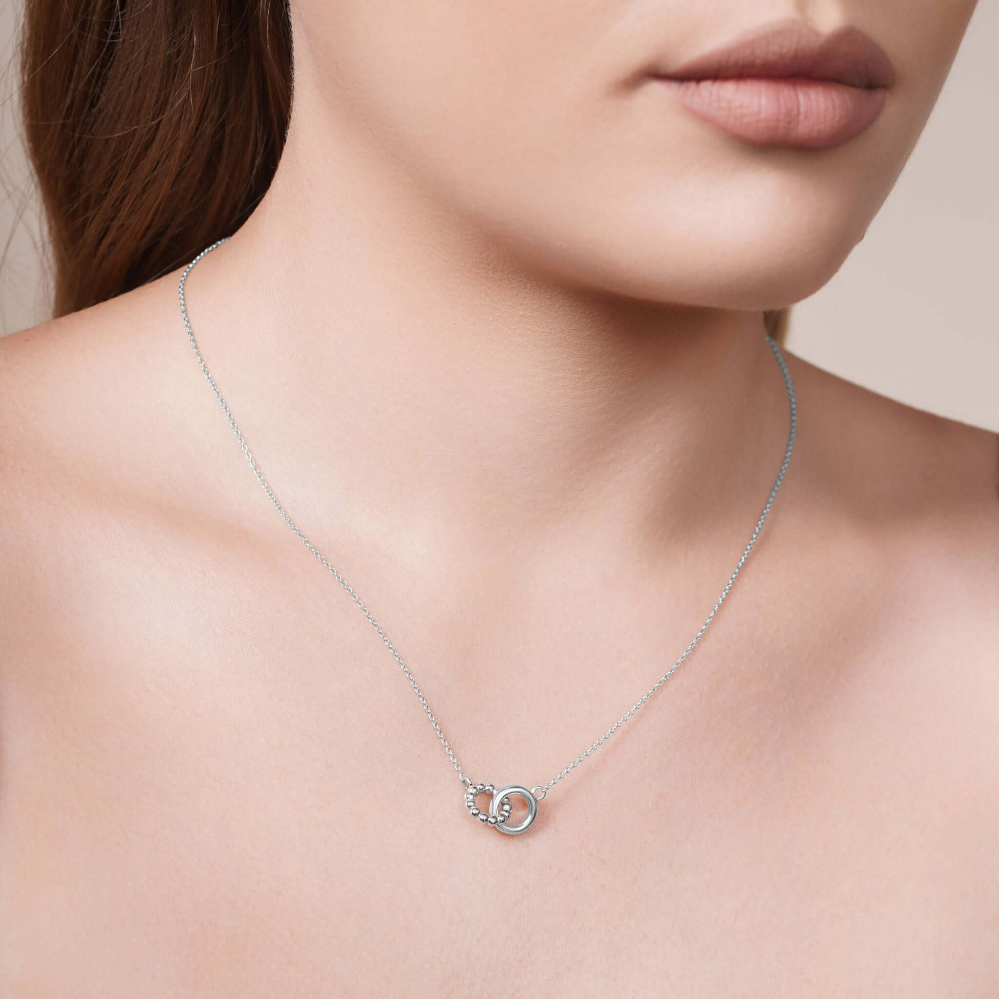 Gold Double Circle Necklace on model, showcasing intertwined circles and delicate design.