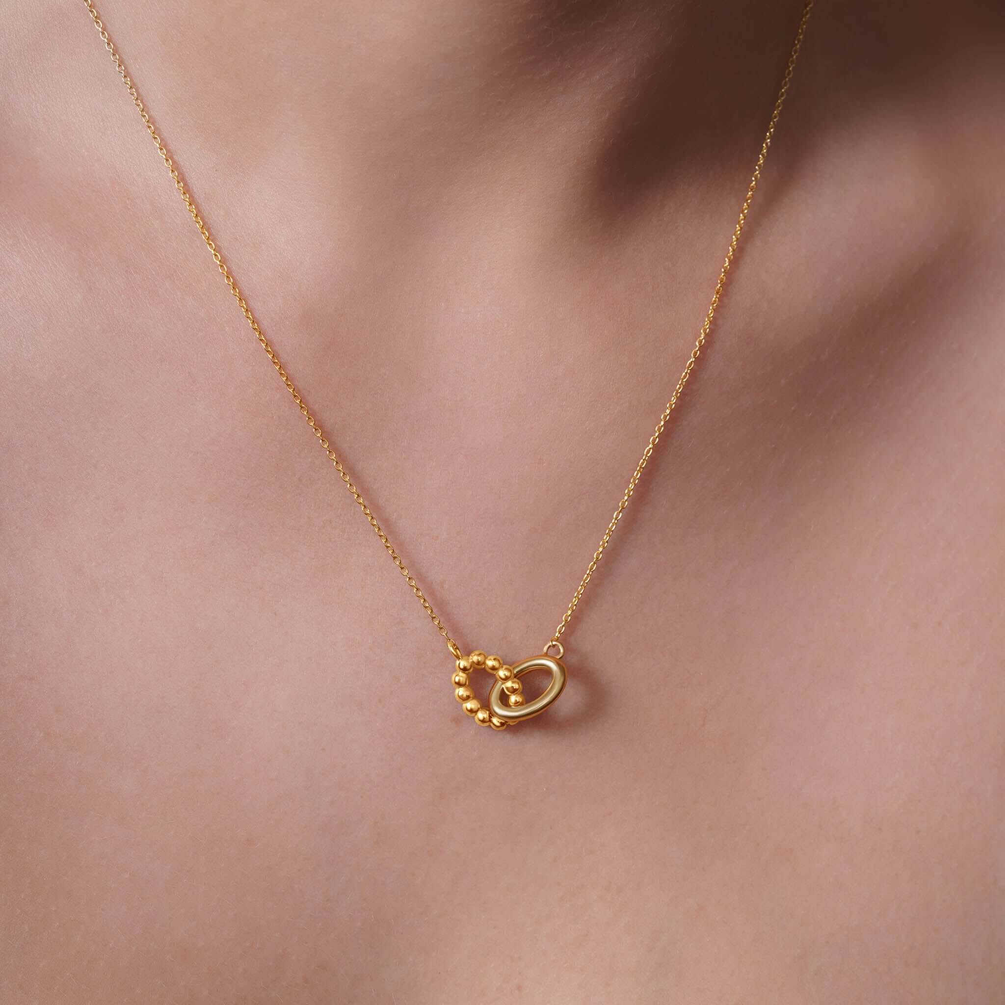 Vermeil Double Oval Necklace showcasing intertwined polished and beaded oval shapes for elegant style.