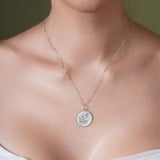 Zodiac Necklace featured on a model, showcasing the zodiac symbol in a medallion design on a sleek chain.