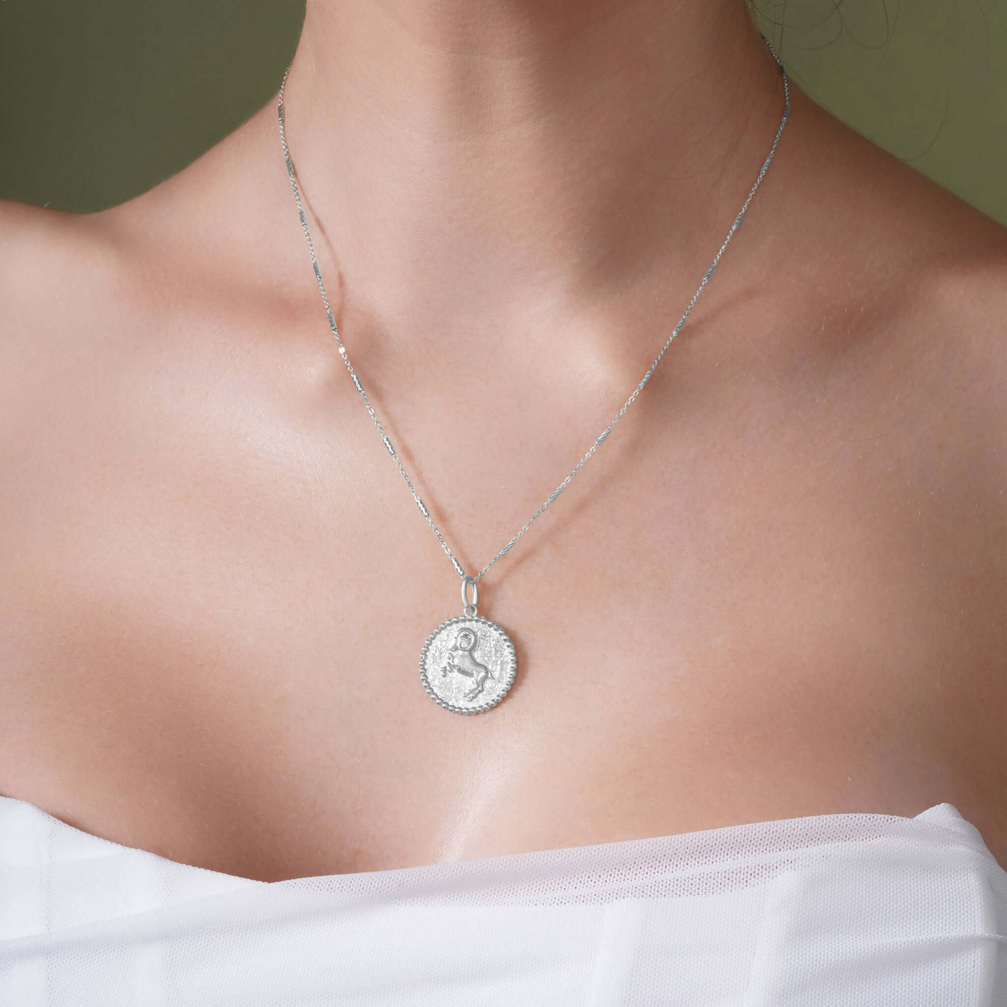 Zodiac Necklace showcasing a zodiac symbol medallion on a sleek chain, perfect for layering or wearing close to the neckline.