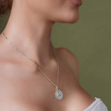 Zodiac Necklace displayed on a model, featuring a medallion style with a zodiac symbol and sleek bar chain.