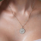 Zodiac Necklace featuring a medallion with a zodiac symbol, hung on a sleek chain, perfect for personal style.