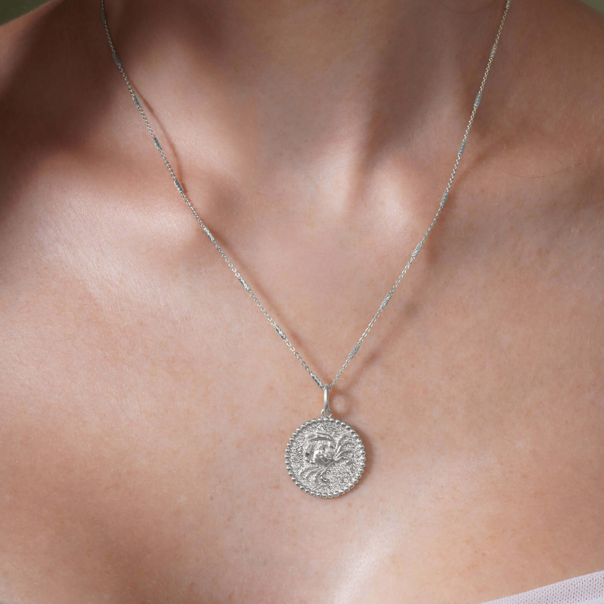 Zodiac Necklace featuring a medallion with a zodiac symbol, hung on a sleek chain, perfect for personal style.