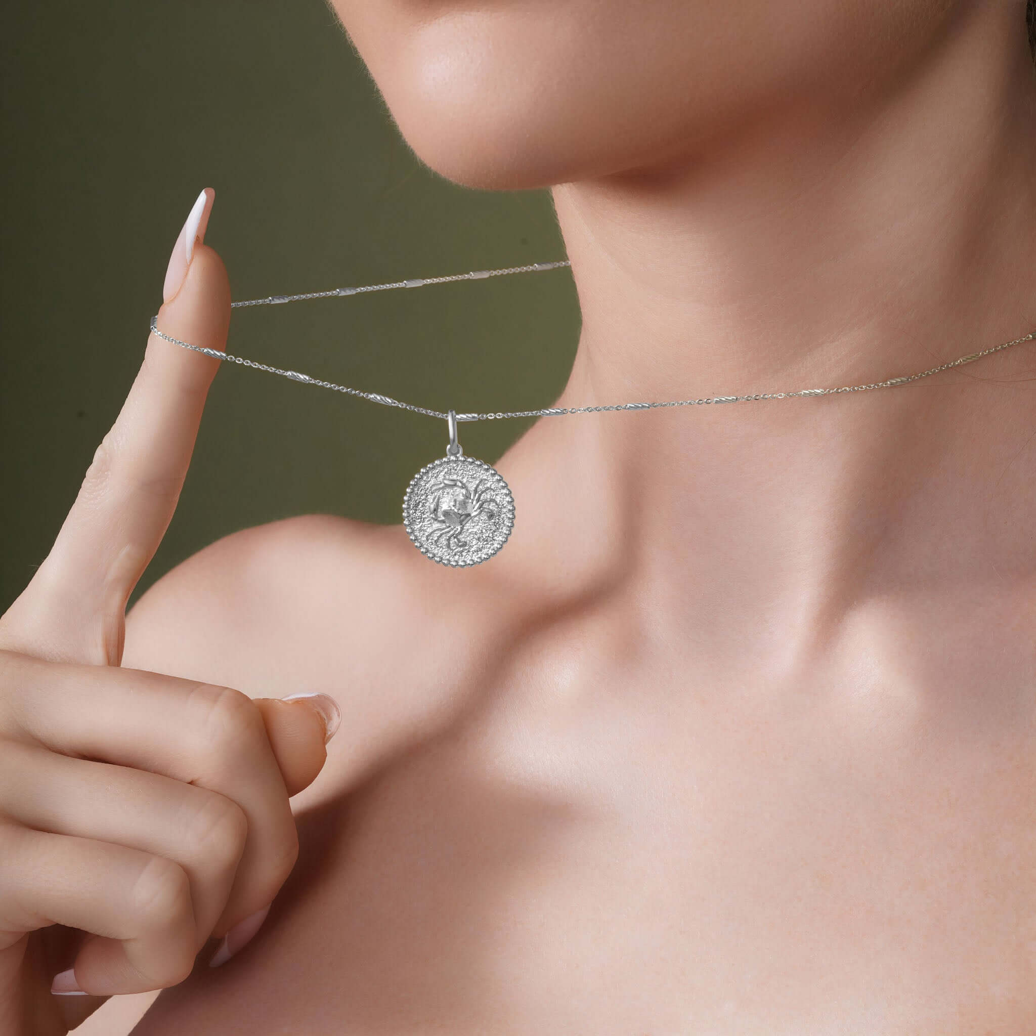 Zodiac Necklace showcased on a model, highlighting the medallion design and sleek chain detail.