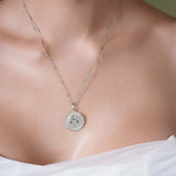 Zodiac Necklace featuring a medallion style pendant on a sleek bar chain worn close to the neckline.