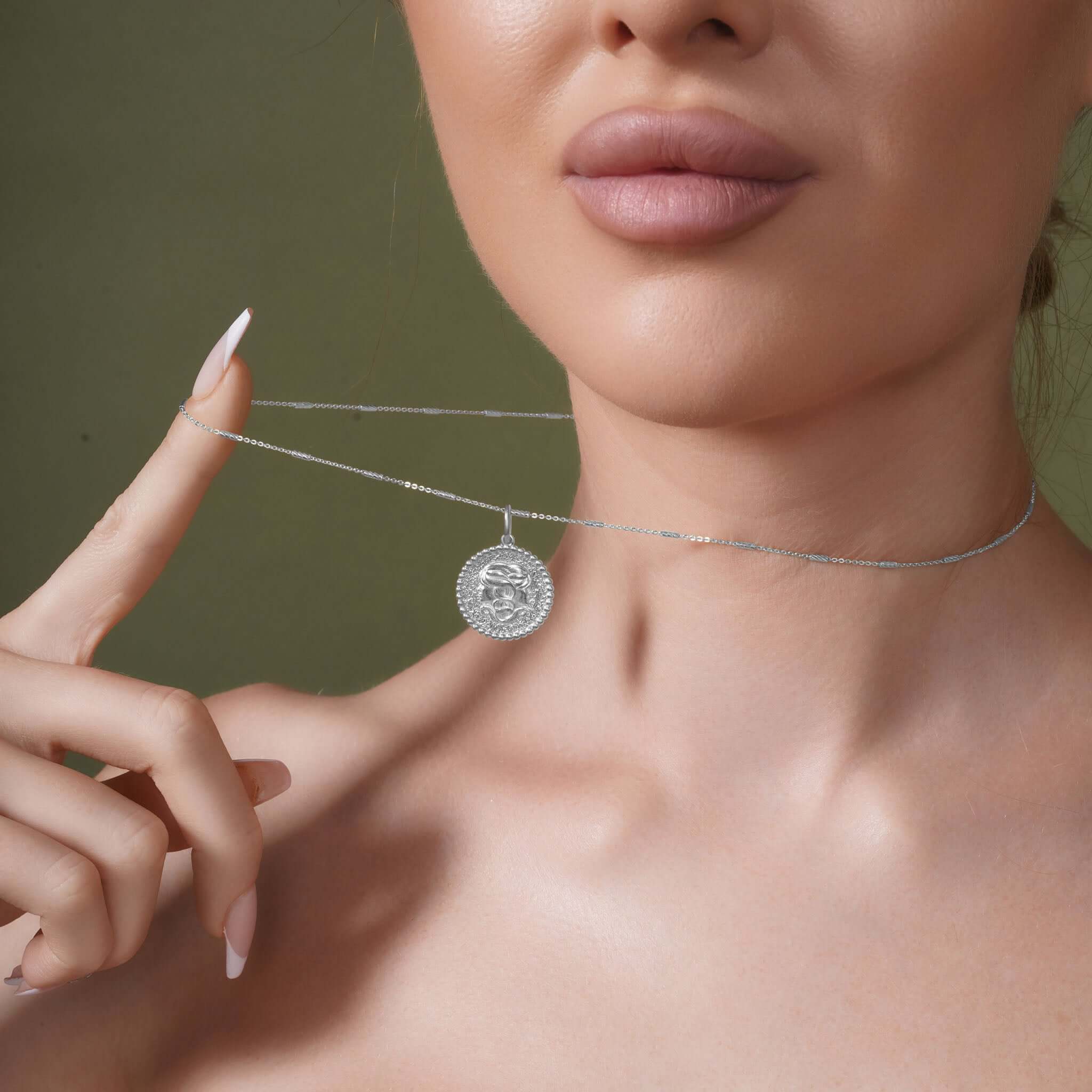 Model showcasing the Zodiac Necklace with a medallion on a sleek bar chain.
