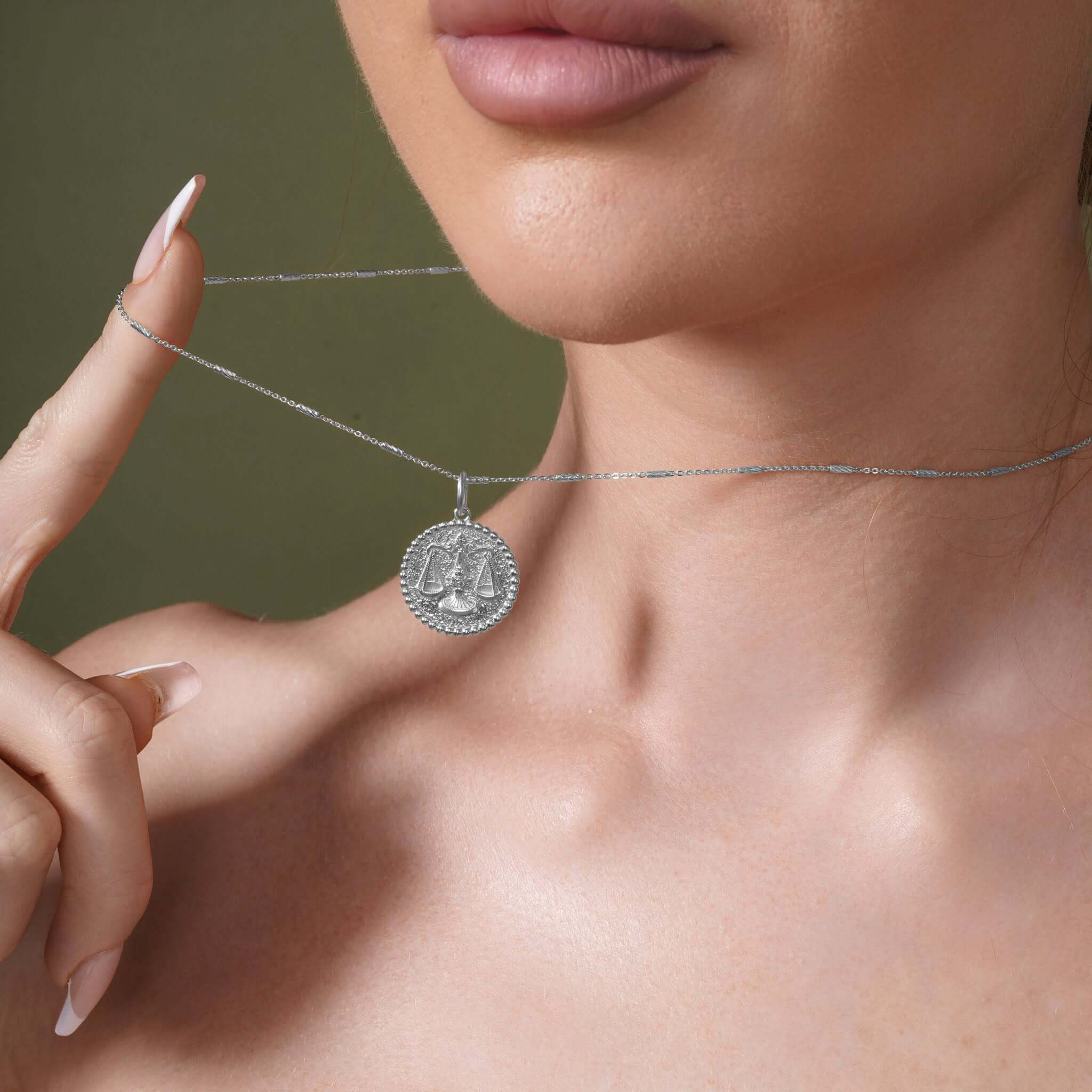 Zodiac Necklace featuring a Libra symbol medallion on a sleek bar chain worn by a model.