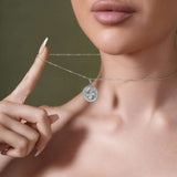 Close-up of a model wearing a Zodiac Necklace, showcasing a medallion pendant and sleek chain.