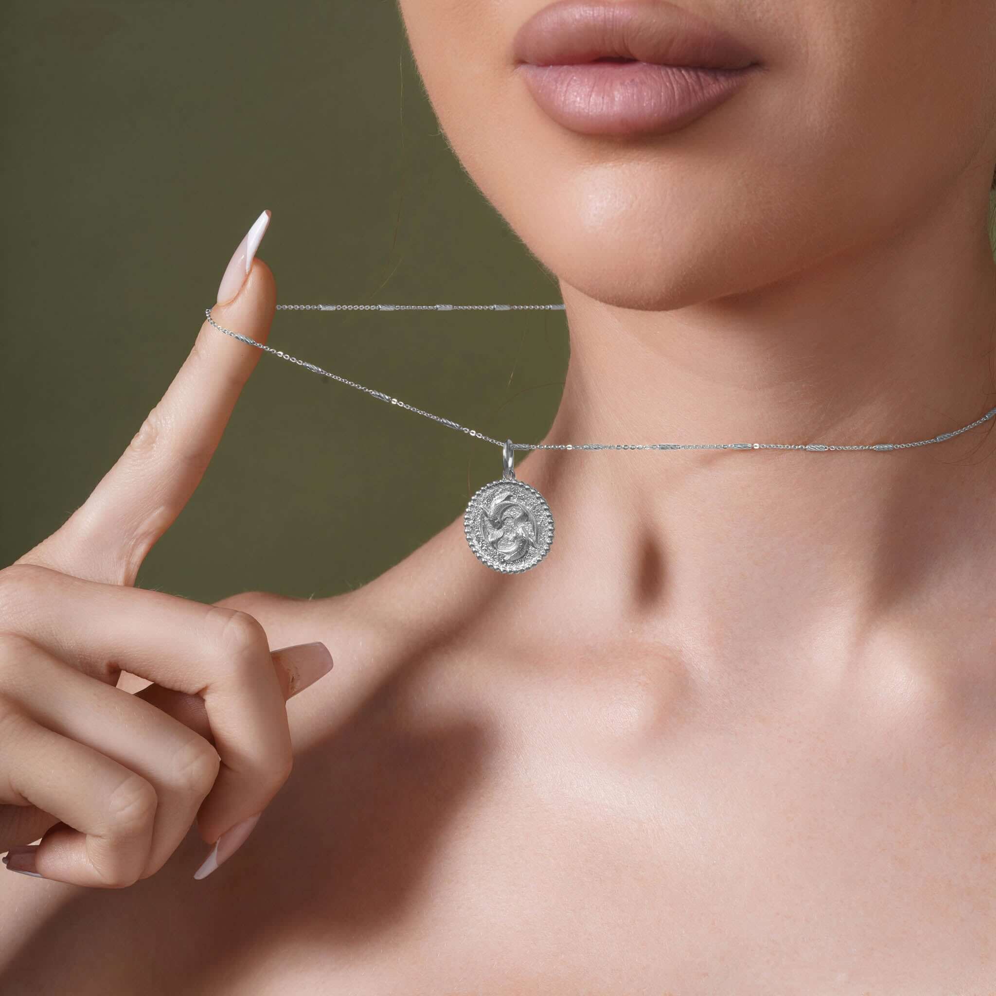 Close-up of a model wearing a Zodiac Necklace, showcasing a medallion pendant and sleek chain.