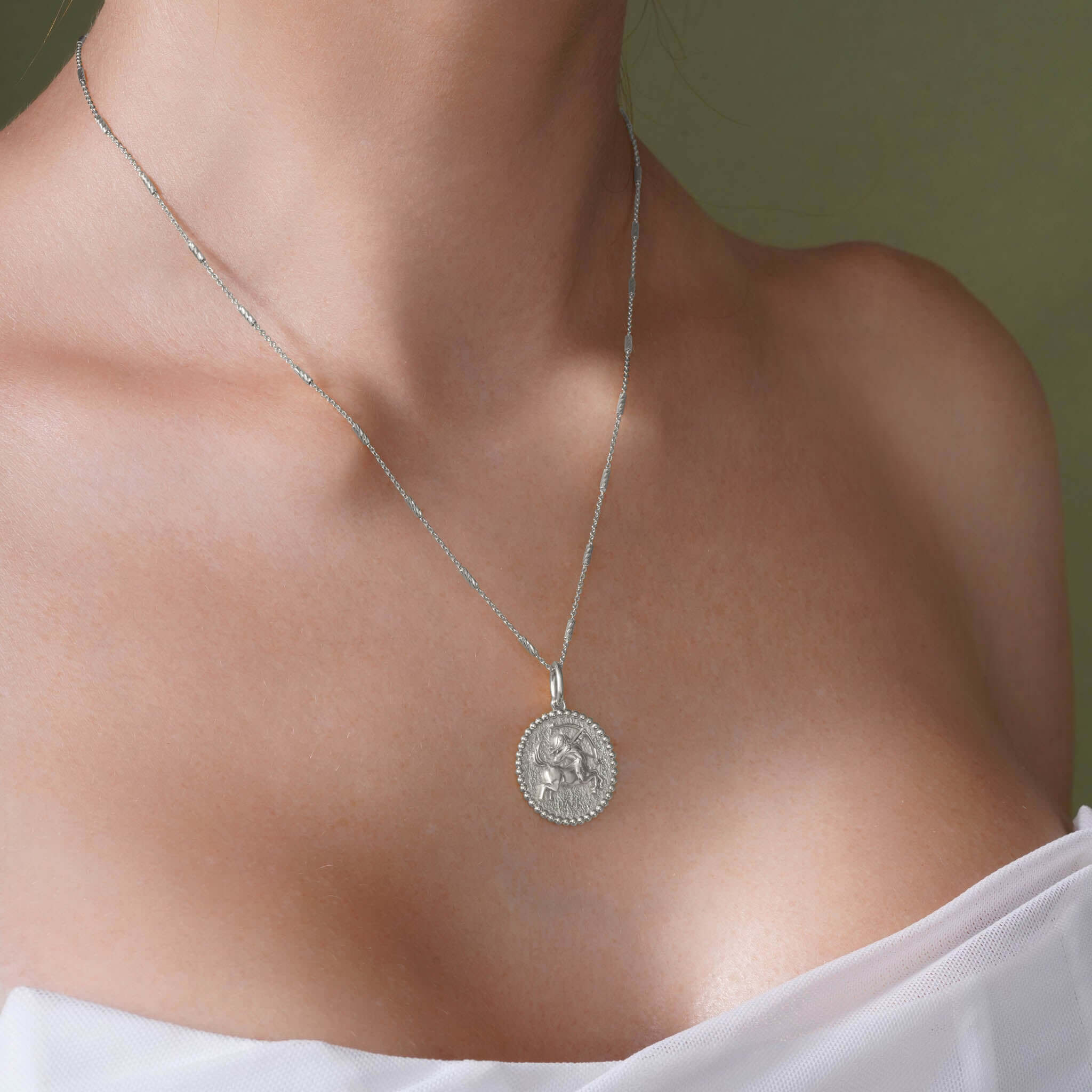 Zodiac Necklace featuring a medallion with a zodiac symbol, suspended from a sleek bar chain.