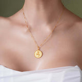 Zodiac Necklace featuring a gold medallion pendant showcasing a zodiac symbol, worn on a delicate chain.