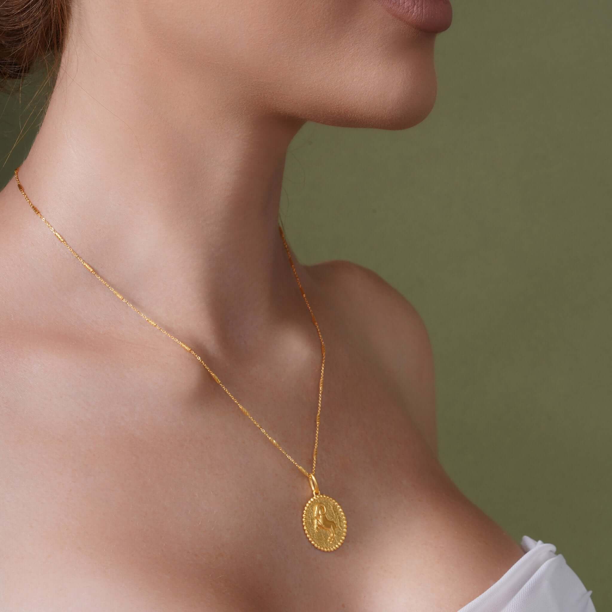 Zodiac Necklace featuring a gold medallion on a sleek chain, highlighting a zodiac symbol for personalized style.