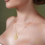 Zodiac Necklace featuring a gold medallion symbol on a delicate chain, perfect for celebrating your star sign.