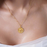Zodiac Necklace featuring a gold medallion on a sleek chain, showcasing a zodiac symbol at the center.