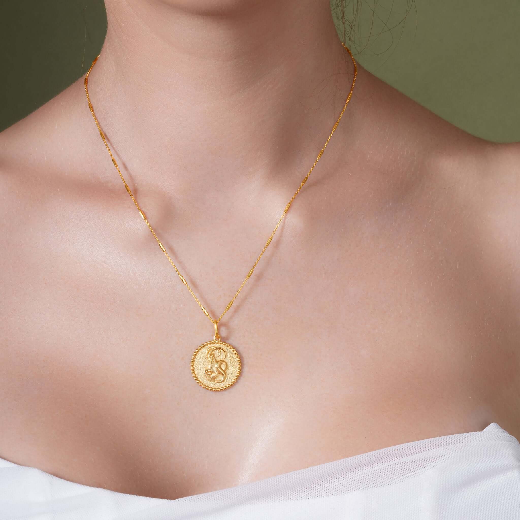 Zodiac Necklace showcasing a gold medallion with star sign symbol, suspended on a sleek chain, perfect for layering.