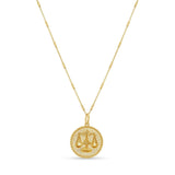 Zodiac Necklace featuring a medallion with balanced scales, textured background, and sleek bar chain.