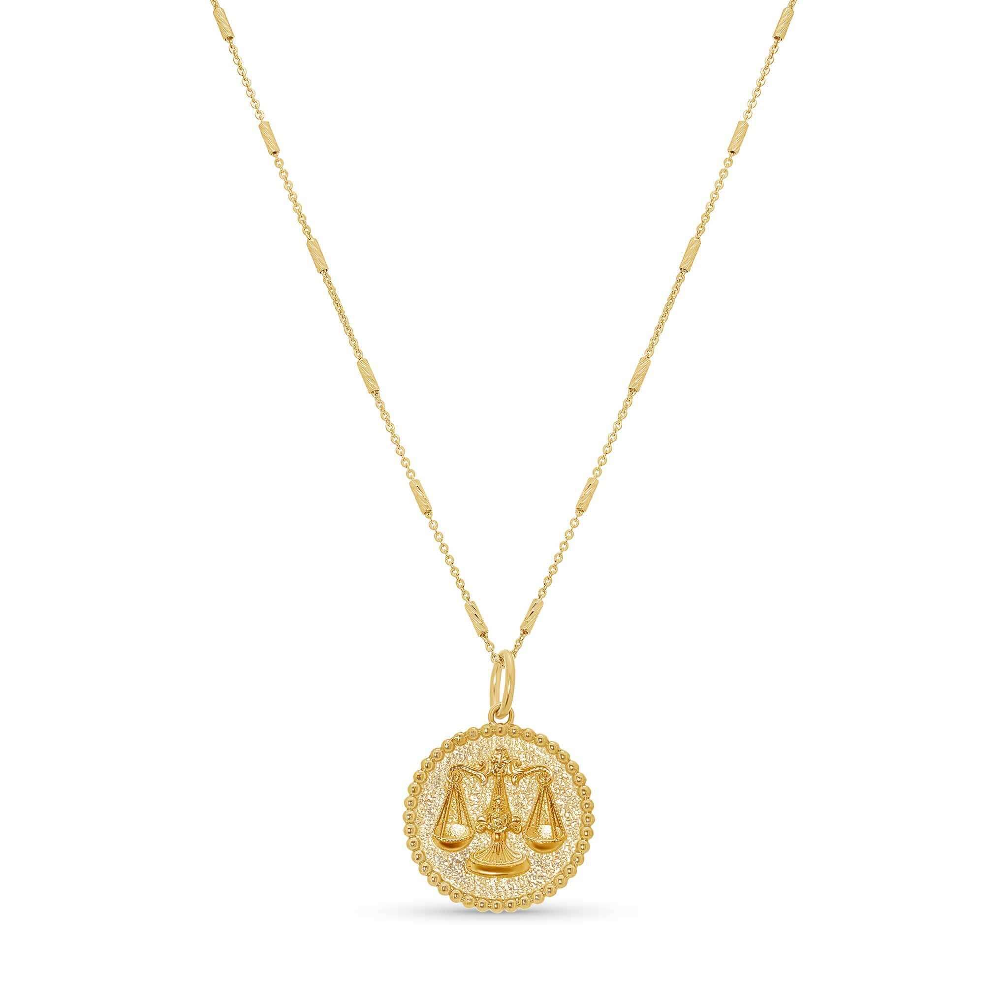 Zodiac Necklace featuring a medallion with balanced scales, textured background, and sleek bar chain.