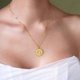 Zodiac Necklace featuring a gold medallion with a zodiac symbol, suspended from a sleek bar chain.
