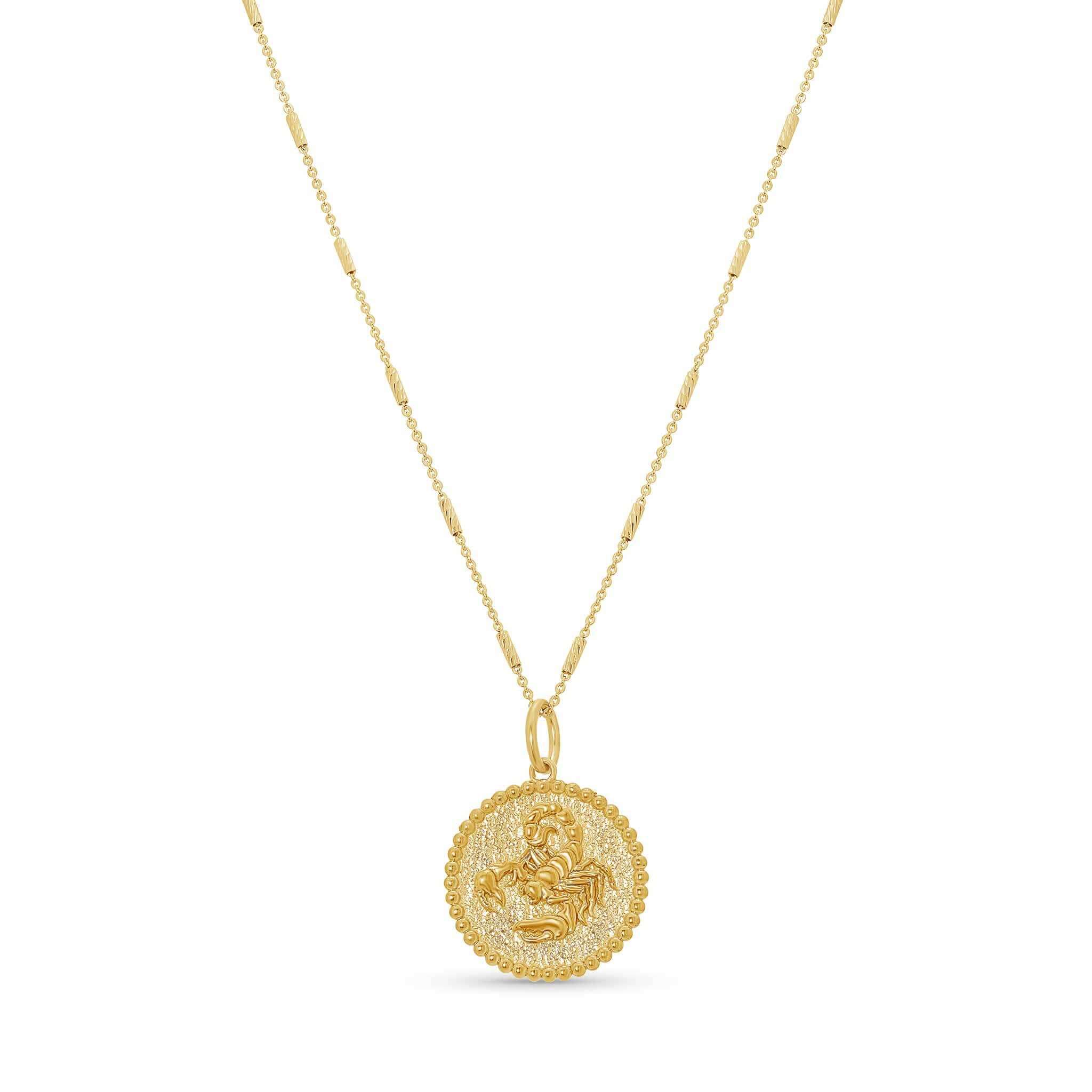 Zodiac Necklace featuring a gold medallion with zodiac symbol on a delicate bar chain, adjustable length.