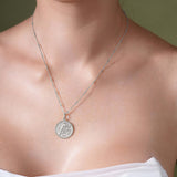 Zodiac Necklace displayed on a model, showcasing a medallion with a zodiac symbol on a sleek bar chain.