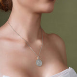 Zodiac Necklace showcased on model, featuring a medallion design with zodiac symbol and sleek bar chain.
