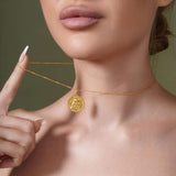 Zodiac Necklace showcasing a medallion with a zodiac symbol, suspended from a sleek bar chain.