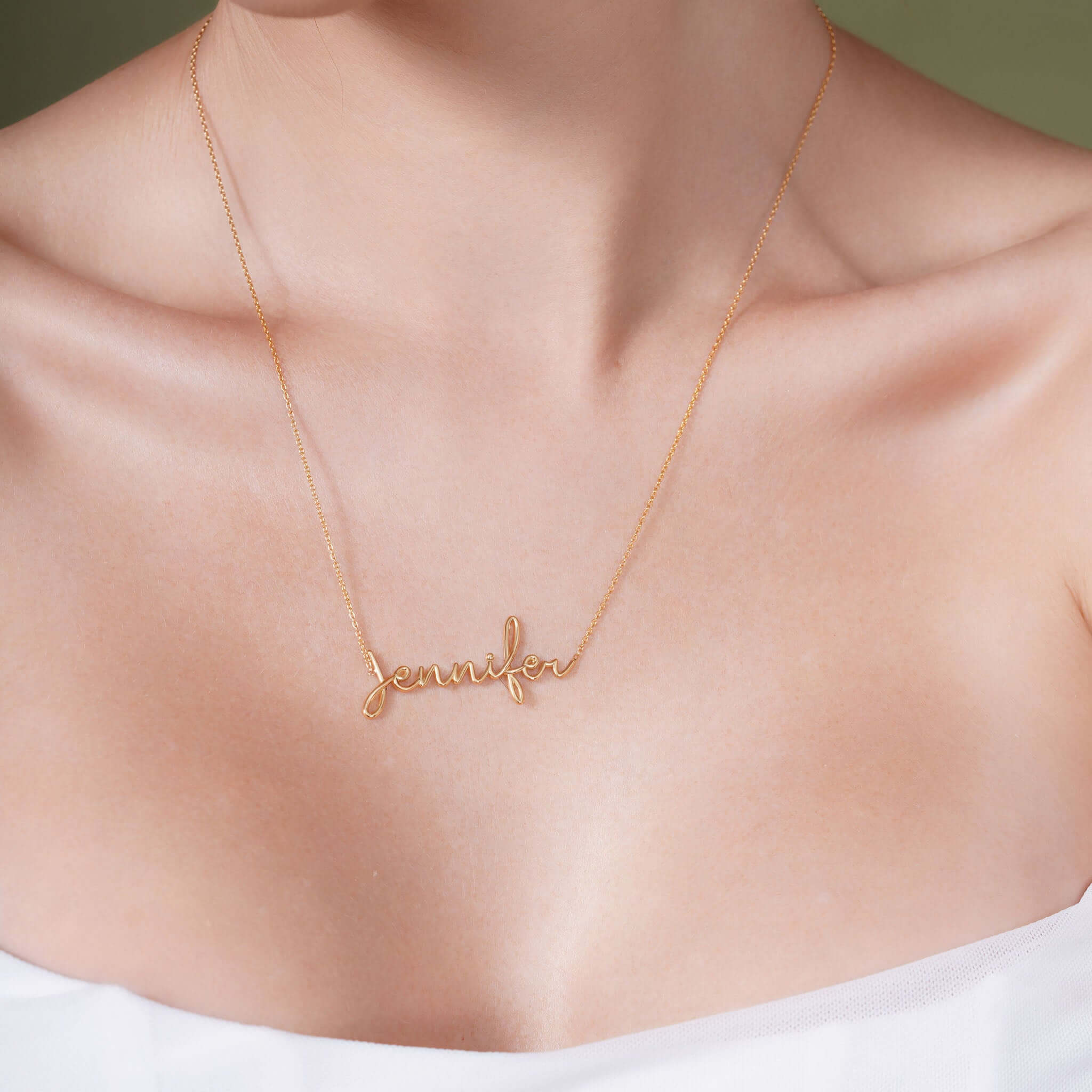 Gold Name Necklace featuring a custom name 'Jennifer' in elegant cursive on a model.