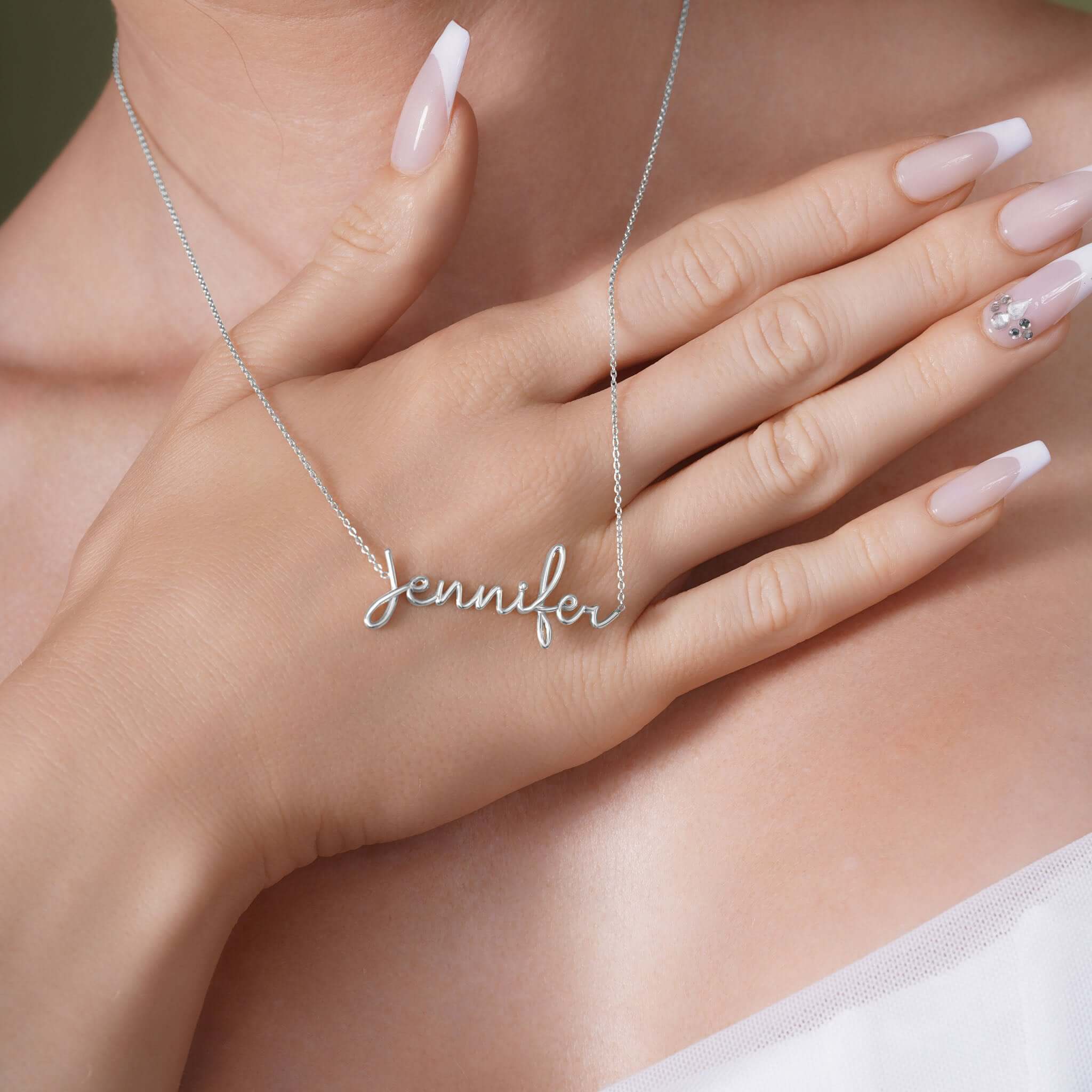 Gold Name Necklace with the name 'Jennifer' showcased on a hand model, highlighting its elegant design.