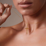 Vermeil Beaded Cross Necklace displayed on a model, showcasing its polished bead-shaped cross and adjustable chain.