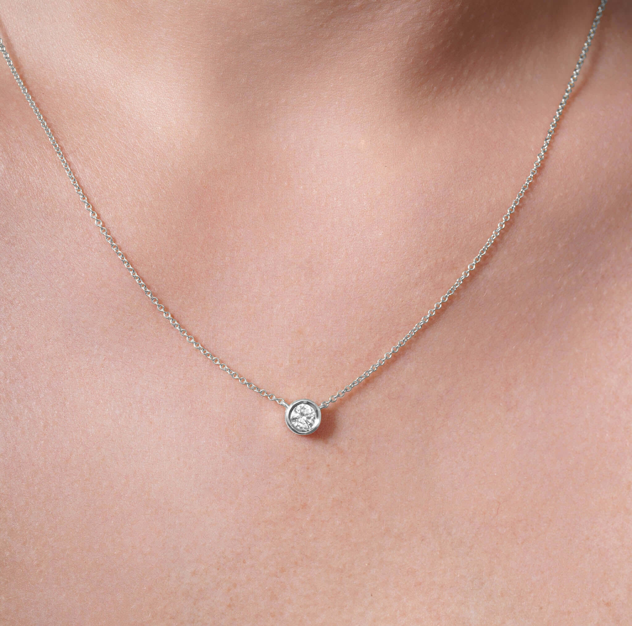 Half Carat Lab Diamond Necklace displayed on a model, featuring a bezel-set lab-grown diamond in a delicate chain.