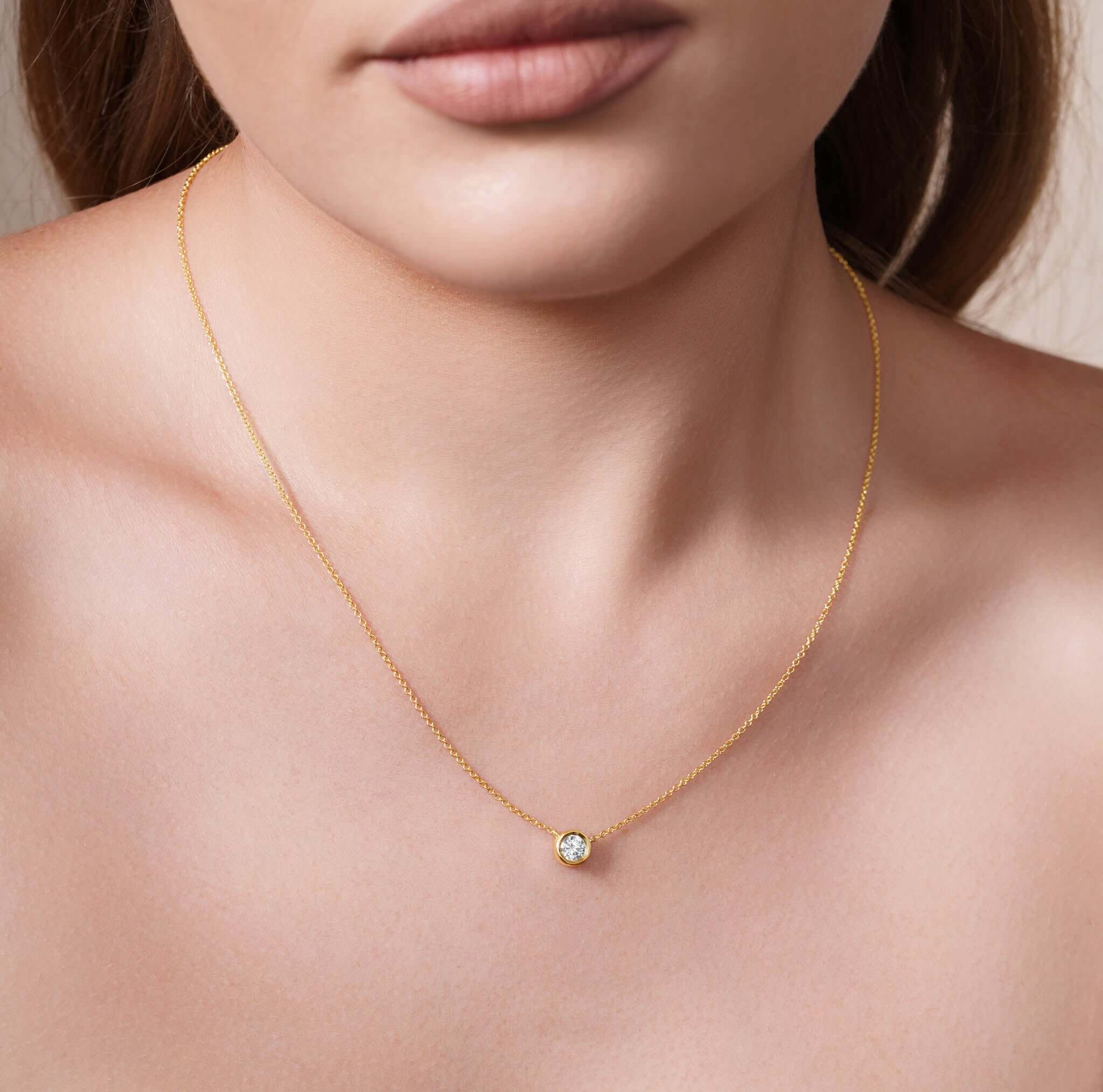 Half Carat Lab Diamond Necklace worn on a model, featuring a bezel-set 0.5 carat lab-grown diamond on a delicate chain.