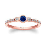 Mia Blue Sapphire three stone diamond promise ring with rose gold band and sparkling diamonds on each side.